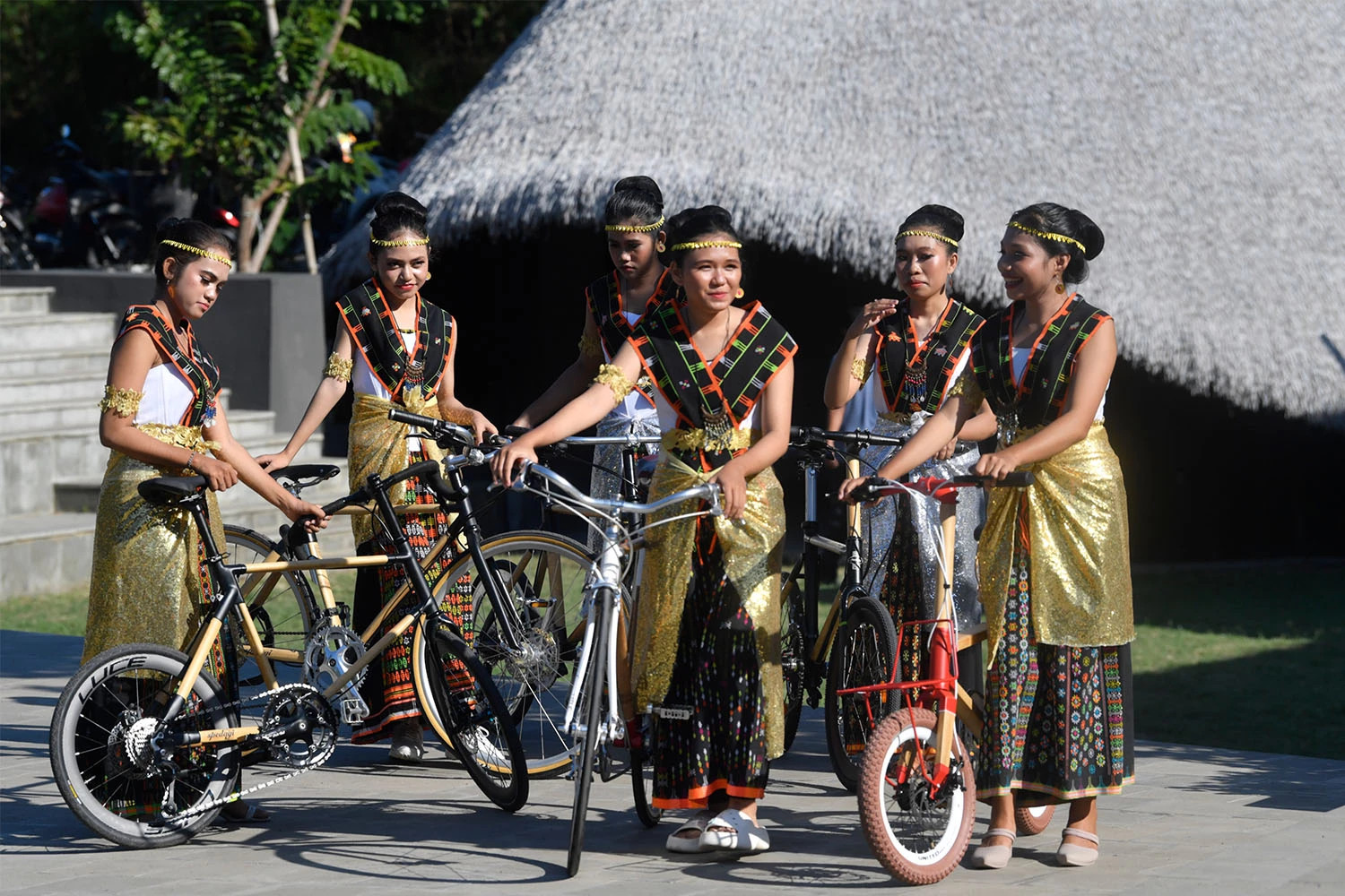 Several teenagers wearing Manggarai traditional attire push bamboo bikes in Labuan Bajo, West Manggarai, East Nusa Tenggara, on Saturday, 6 May 2023. The bikes are planned to be souvenirs for heads of state attending the 42nd ASEAN Summit in Labuan Bajo. ANTARA FOTO/Zabur Karuru/aww.